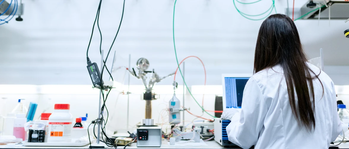 A scientist working on a laboratory table.